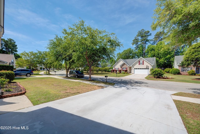 4029 Berberis Way, Wilmington, NC 28412 - view of grassy yard featuring concrete driveway and an attached garage