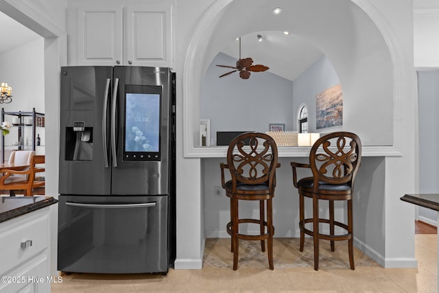 3 Merion Cir, Pinehurst, NC 28374 - kitchen featuring stainless steel refrigerator with ice dispenser, white cabinets, a ceiling fan, vaulted ceiling, and baseboards