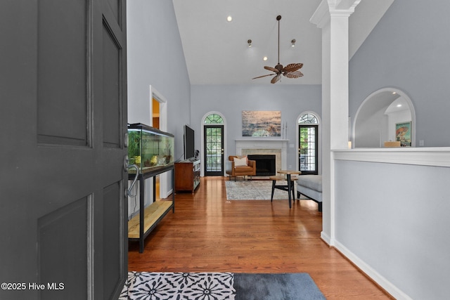 3 Merion Cir, Pinehurst, NC 28374 - living area with high vaulted ceiling, a ceiling fan, wood finished floors, a fireplace, and baseboards