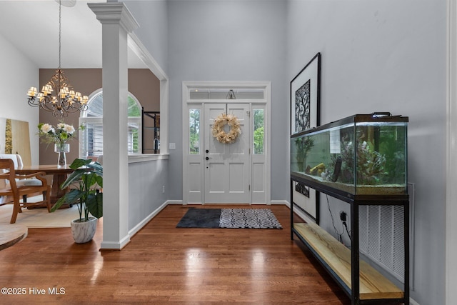 3 Merion Cir, Pinehurst, NC 28374 - foyer entrance featuring a towering ceiling, wood finished floors, a chandelier, and baseboards