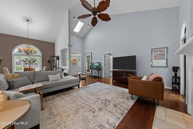 3 Merion Cir, Pinehurst, NC 28374 - living area featuring high vaulted ceiling, a ceiling fan, a chandelier, wood finished floors, and a skylight