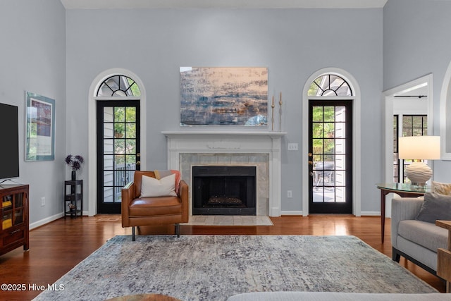 3 Merion Cir, Pinehurst, NC 28374 - living room with wood finished floors, plenty of natural light, a high ceiling, a fireplace, and baseboards