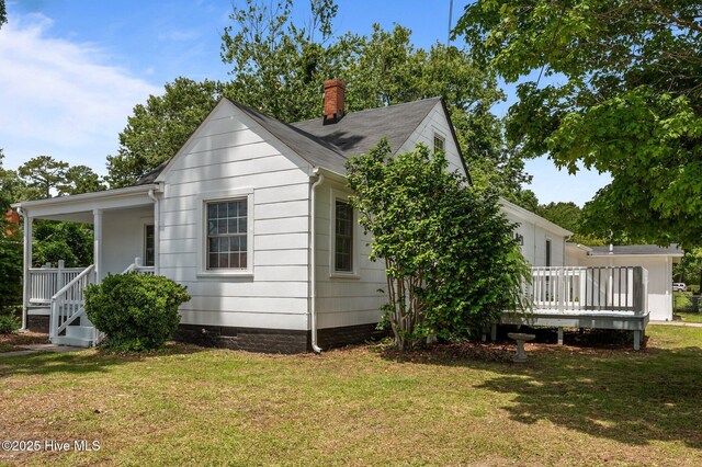 306 Oak Dr, Tarboro, NC 27886 - view of property exterior with a yard, covered porch, and a chimney
