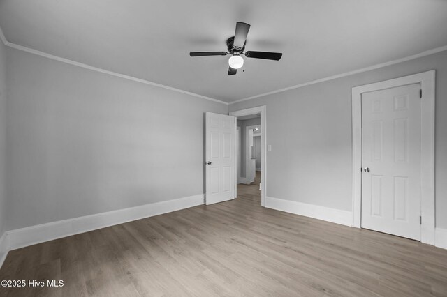 306 Oak Dr, Tarboro, NC 27886 - unfurnished bedroom with ornamental molding, wood finished floors, baseboards, and ceiling fan
