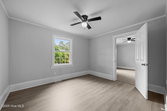 306 Oak Dr, Tarboro, NC 27886 - unfurnished bedroom with ornamental molding, baseboards, light wood-style flooring, and ceiling fan