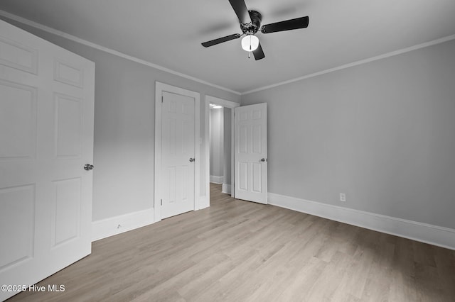 306 Oak Dr, Tarboro, NC 27886 - unfurnished bedroom featuring wood finished floors, crown molding, baseboards, and ceiling fan
