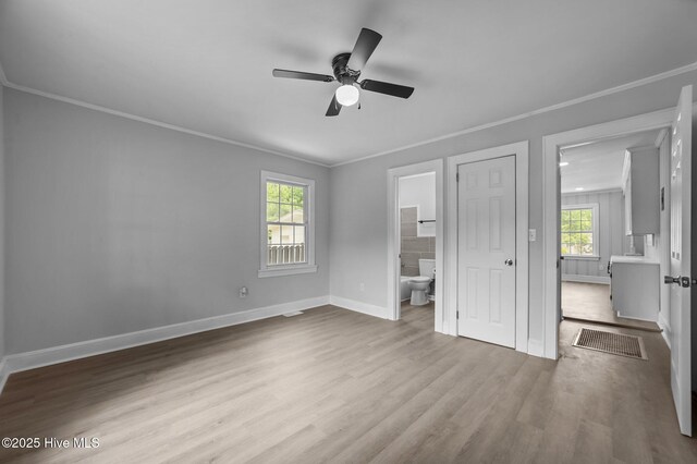 306 Oak Dr, Tarboro, NC 27886 - unfurnished bedroom with ornamental molding, wood finished floors, baseboards, ensuite bath, and a ceiling fan