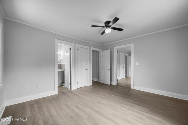 306 Oak Dr, Tarboro, NC 27886 - unfurnished bedroom featuring wood finished floors, baseboards, crown molding, connected bathroom, and a ceiling fan