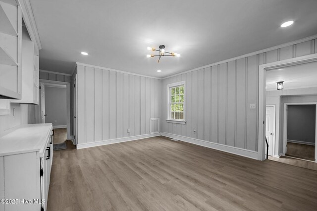 306 Oak Dr, Tarboro, NC 27886 - unfurnished living room featuring ornamental molding, a chandelier, wood finished floors, baseboards, and recessed lighting