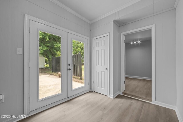 306 Oak Dr, Tarboro, NC 27886 - doorway featuring ornamental molding, wood finished floors, a decorative wall, and baseboards