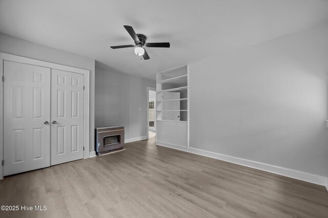 306 Oak Dr, Tarboro, NC 27886 - unfurnished living room featuring baseboards, ceiling fan, and wood finished floors