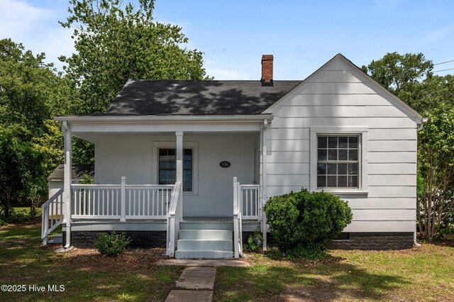 306 Oak Dr, Tarboro, NC 27886 - view of front facade featuring a chimney, a porch, and roof with shingles