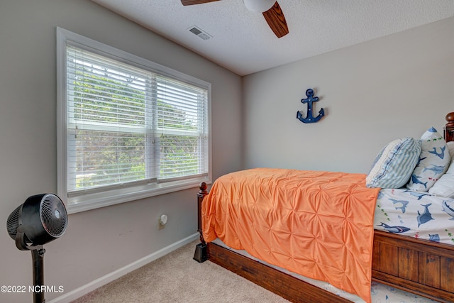 316 Bay Cir, North Topsail Beach, NC 28460 - bedroom with carpet floors, a textured ceiling, baseboards, and ceiling fan