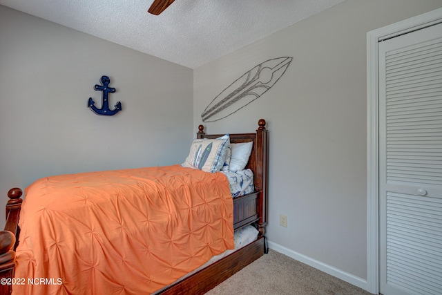 316 Bay Cir, North Topsail Beach, NC 28460 - bedroom with carpet flooring, a textured ceiling, baseboards, and ceiling fan