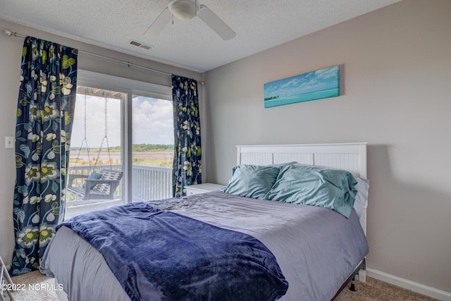 316 Bay Cir, North Topsail Beach, NC 28460 - bedroom featuring carpet flooring, baseboards, a ceiling fan, access to outside, and a textured ceiling