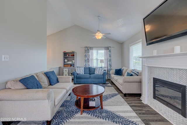 316 Bay Cir, North Topsail Beach, NC 28460 - living area with dark wood-type flooring, vaulted ceiling, a tiled fireplace, and a ceiling fan