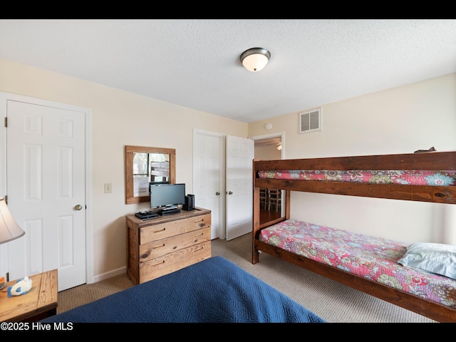 1013 Carolina Beach Ave N Unit 1F, Carolina Beach, NC 28428 - bedroom with carpet and a textured ceiling