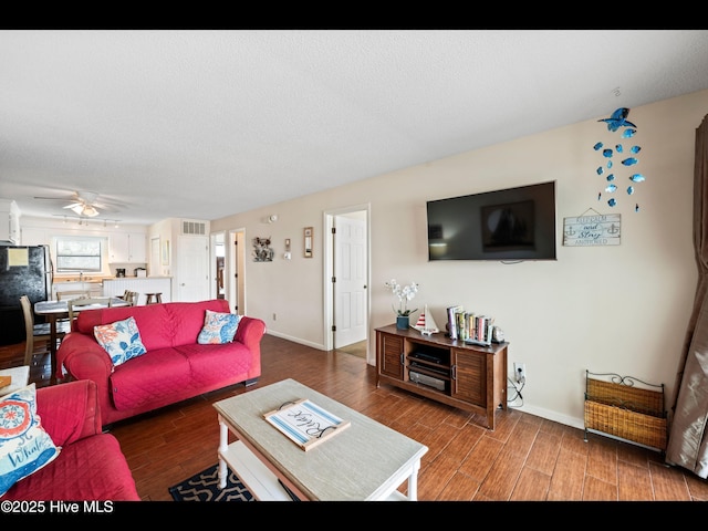 1013 Carolina Beach Ave N Unit 1F, Carolina Beach, NC 28428 - living area featuring wood finished floors, baseboards, and ceiling fan