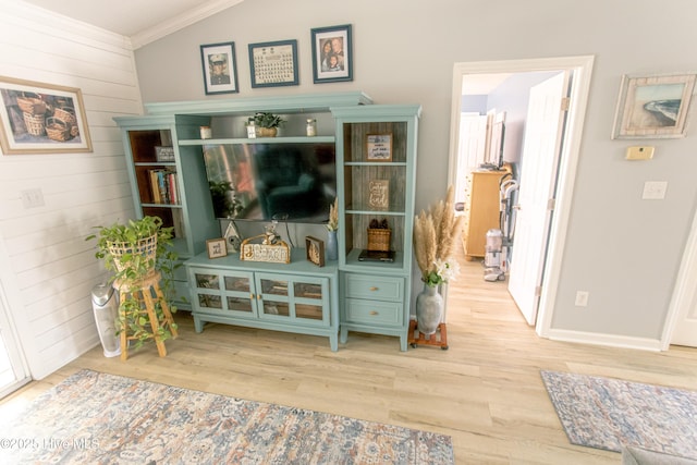 132 Charlton Rd, Hubert, NC 28539 - living area featuring wood finished floors, ornamental molding, wooden walls, baseboards, and healthy amount of natural light