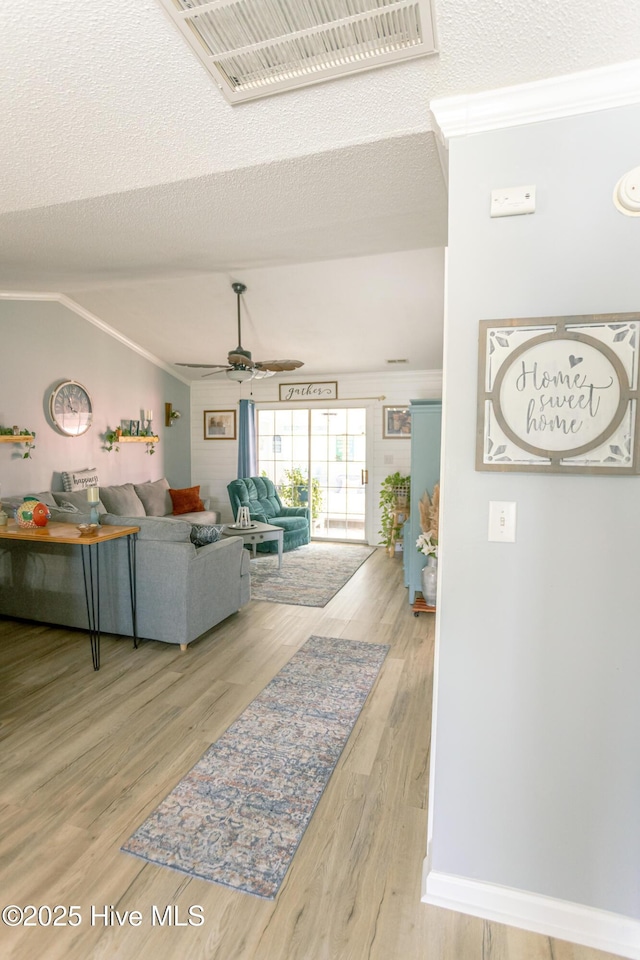 132 Charlton Rd, Hubert, NC 28539 - living area featuring wood finished floors, ceiling fan, lofted ceiling, and ornamental molding