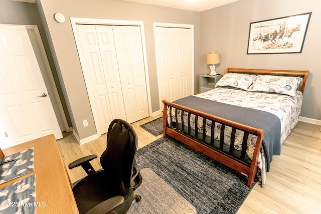 132 Charlton Rd, Hubert, NC 28539 - bedroom featuring wood finished floors, two closets, baseboards, and an office area