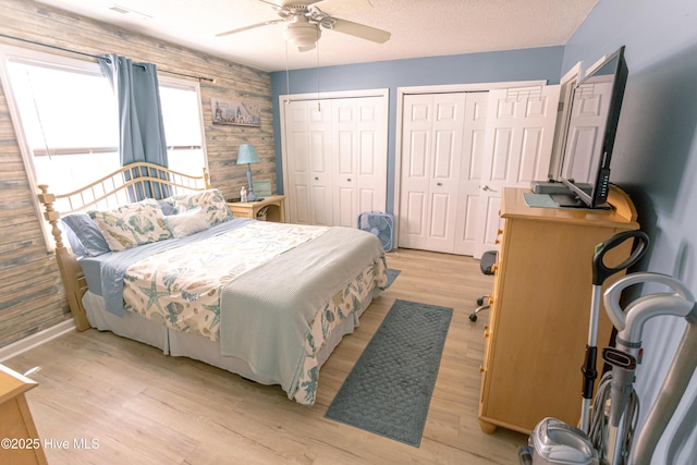 132 Charlton Rd, Hubert, NC 28539 - bedroom with light wood-style floors, two closets, ceiling fan, and baseboards