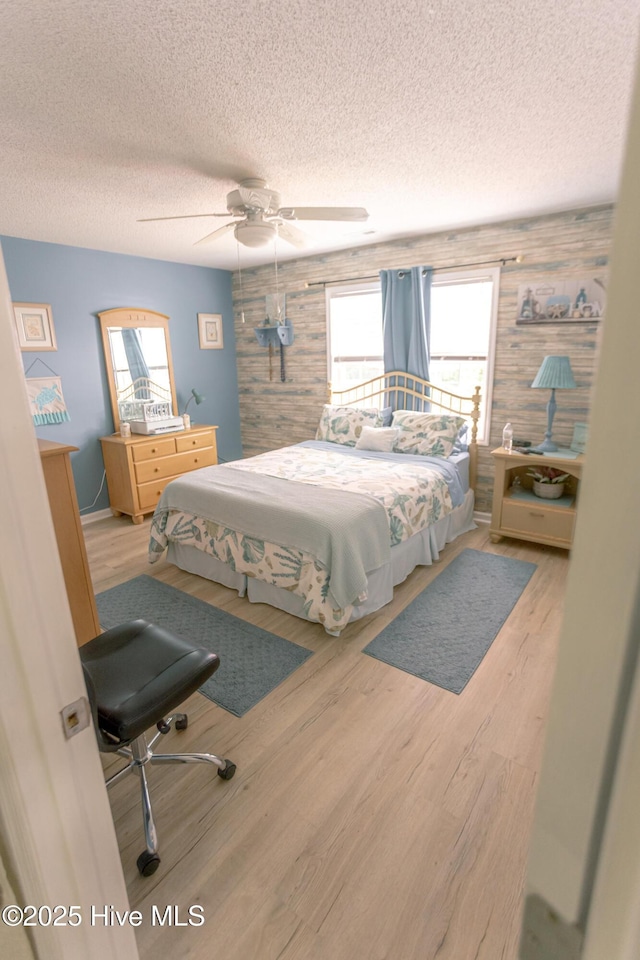 132 Charlton Rd, Hubert, NC 28539 - bedroom featuring a textured ceiling, multiple windows, wood finished floors, and ceiling fan