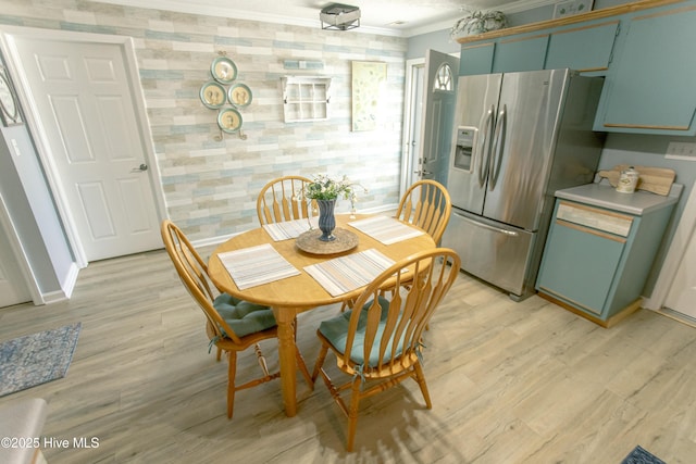 132 Charlton Rd, Hubert, NC 28539 - dining room with light wood-style floors, ornamental molding, wallpapered walls, and baseboards
