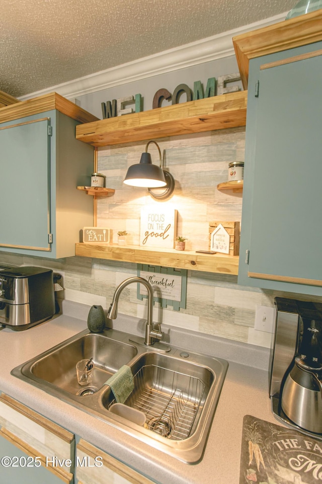 132 Charlton Rd, Hubert, NC 28539 - kitchen view of a sink, open shelves, decorative backsplash, ornamental molding, and light countertops