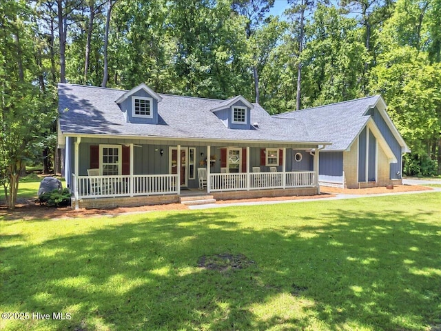2 Pinewood Dr, Calabash, NC 28467 - cape cod-style house with covered porch, a front lawn, and roof with shingles