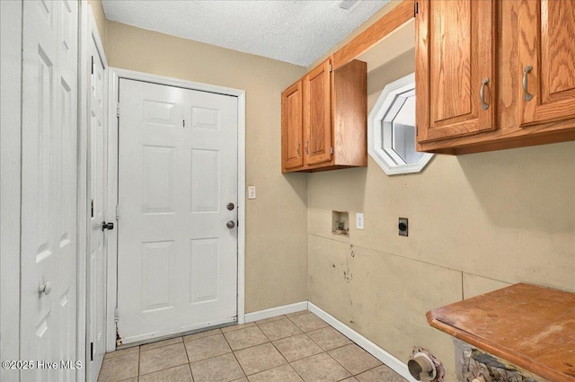 2 Pinewood Dr, Calabash, NC 28467 - laundry area featuring cabinet space, washer hookup, light tile patterned floors, baseboards, and a textured ceiling