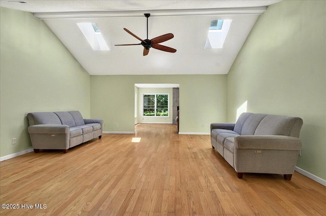 2 Pinewood Dr, Calabash, NC 28467 - living area featuring a skylight, ceiling fan, light wood finished floors, baseboards, and high vaulted ceiling