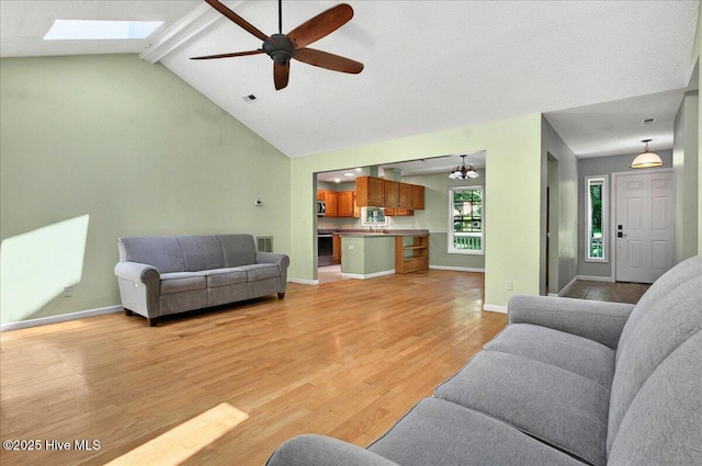 2 Pinewood Dr, Calabash, NC 28467 - living room with light wood-type flooring, ceiling fan, a skylight, and baseboards