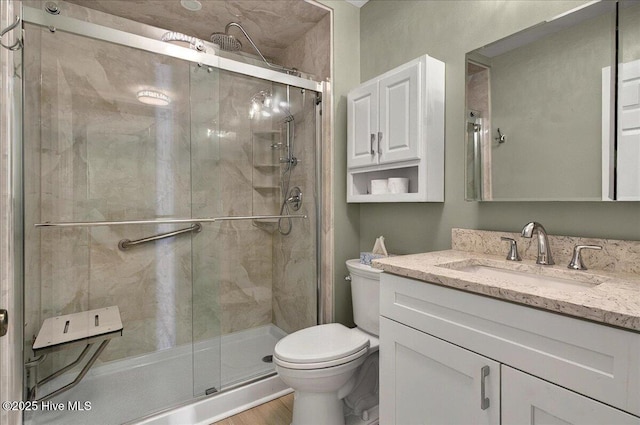 2 Pinewood Dr, Calabash, NC 28467 - bathroom featuring toilet, vanity, a stall shower, and wood finished floors
