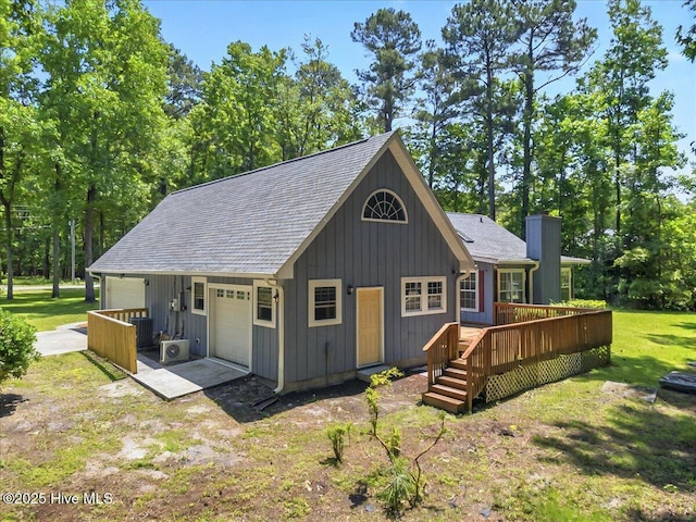 2 Pinewood Dr, Calabash, NC 28467 - back of property with a wooden deck, a shingled roof, and a lawn
