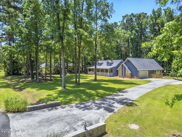 2 Pinewood Dr, Calabash, NC 28467 - view of front of house with a front lawn, asphalt driveway, covered porch, and a garage