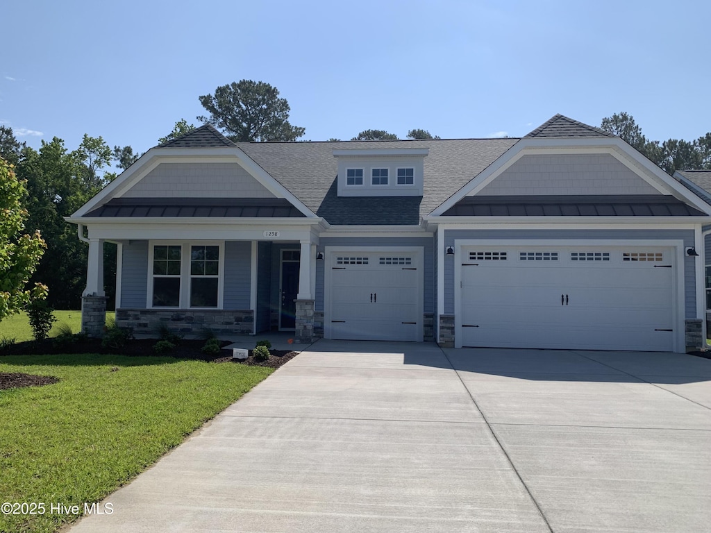 1258 Halter Pl, Calabash, NC 28467 - craftsman-style house with a standing seam roof, a garage, a front yard, and driveway