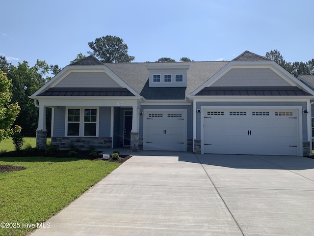 1258 Halter Pl, Calabash, NC 28467 - craftsman-style house with a standing seam roof, a garage, a front yard, and driveway