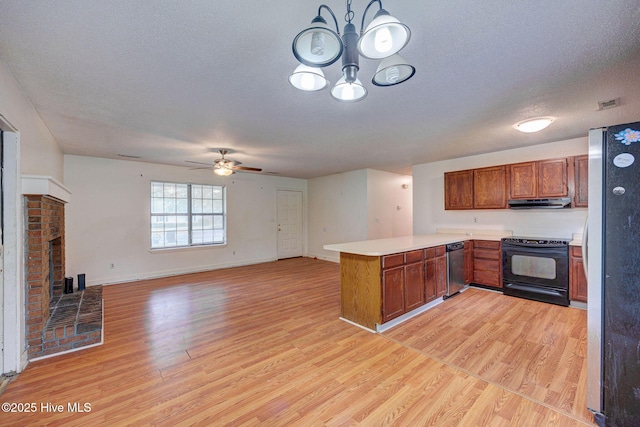 4448 Jamey Ct, Wilmington, NC 28405 - kitchen featuring stainless steel appliances, a peninsula, light wood finished floors, brown cabinets, and a textured ceiling