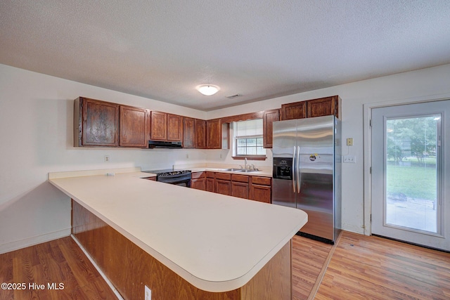 4448 Jamey Ct, Wilmington, NC 28405 - kitchen featuring stainless steel refrigerator with ice dispenser, range hood, a sink, black electric range, and a peninsula