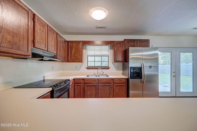 4448 Jamey Ct, Wilmington, NC 28405 - kitchen with stainless steel refrigerator with ice dispenser, a sink, black range with electric stovetop, a textured ceiling, and light countertops