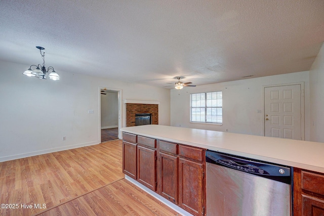 4448 Jamey Ct, Wilmington, NC 28405 - kitchen with stainless steel dishwasher, a ceiling fan, a fireplace, open floor plan, and light countertops