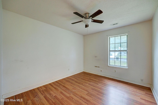 4448 Jamey Ct, Wilmington, NC 28405 - empty room with light wood-style floors, ceiling fan, baseboards, and a textured ceiling