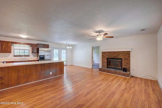 4448 Jamey Ct, Wilmington, NC 28405 - kitchen featuring stainless steel fridge with ice dispenser, light countertops, a textured ceiling, open floor plan, and a sink