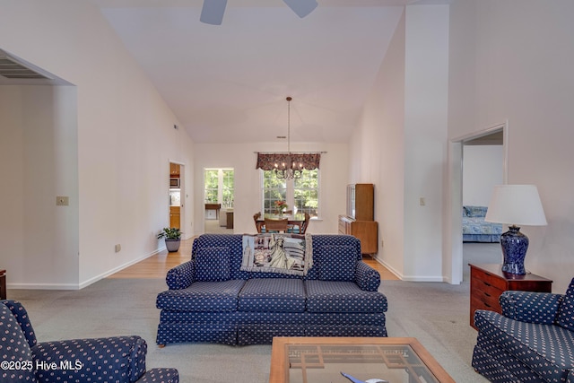 315 Thomas Pl, Washington, NC 27889 - carpeted living room featuring a chandelier, baseboards, high vaulted ceiling, and a ceiling fan