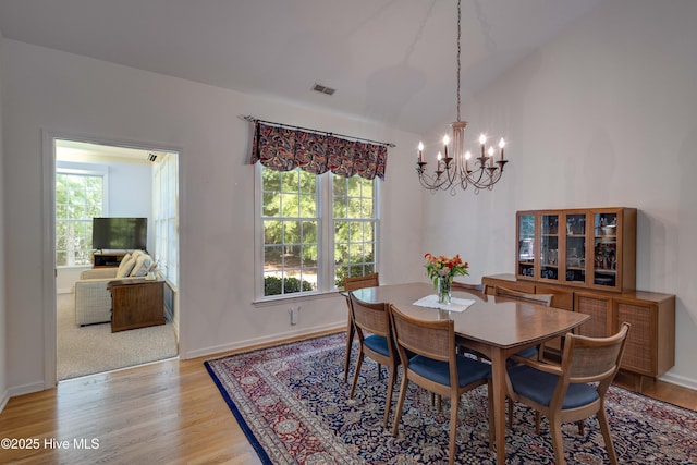 315 Thomas Pl, Washington, NC 27889 - dining room with a chandelier, healthy amount of natural light, light wood-style floors, lofted ceiling, and baseboards