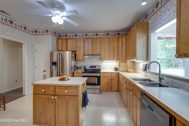 315 Thomas Pl, Washington, NC 27889 - kitchen featuring stainless steel appliances, a sink, under cabinet range hood, light flooring, and light countertops