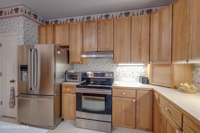 315 Thomas Pl, Washington, NC 27889 - kitchen featuring stainless steel appliances, under cabinet range hood, light countertops, wallpapered walls, and backsplash