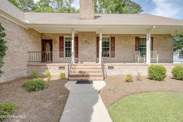 315 Thomas Pl, Washington, NC 27889 - property entrance featuring brick siding, a chimney, a porch, and a shingled roof