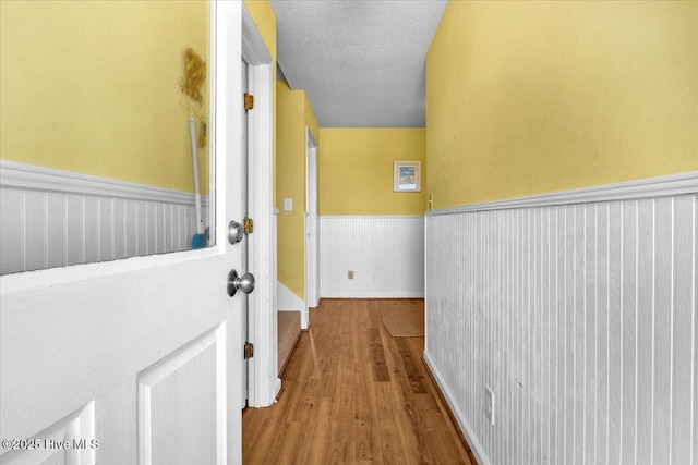 939 Ocean Blvd W, Holden Beach, NC 28462 - hallway featuring a wainscoted wall and wood finished floors